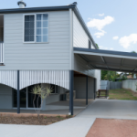 An old Queenslander house that has been lifted and renovated with a livable space under the original structure.
