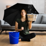 A woman sits in her loungeroom with an umbrella as she uses a bucket to collect the water leaking from her ceiling. Special Levies are typically imposed on owners to deal with building problems like this. The majority are probably water penetration related - roof membrane failures, windows not sealing, balconies not draining etc. A lot of investors accountants, think a Special Levy can be claimed as an immediate write-off and treated in the same way as regular strata contributions. It often can’t.