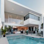 A modern double storey house overlooking a pool. Property owners renting properties on short term rental platforms such as Airbnb need to ensure that they are reporting their rental income correctly.