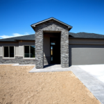 A brand new house with grey brickwork and a grey garage door, where the garden and turf has not been planted yet. New properties that have not been lived in can depreciate the Assets in the property, as well as the building.