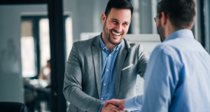 Two business partners shake hands, smiling. Depreciator is here to work with our business partners to make tax season easier.