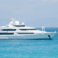 A charter boat sailing through a blue sea. Charter boats are considered an Asset in terms of depreciation.