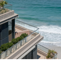 A block of apartments overlooking the ocean.