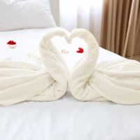 Two towels shaped as swans make a heart on a bed in a "house of ill repute". When a bed is part of a business, it can be depreciated.